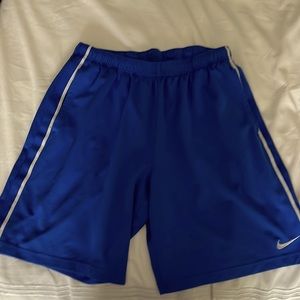 Men’s Nike athletic shorts with elastic band. Size L measures 21” length.